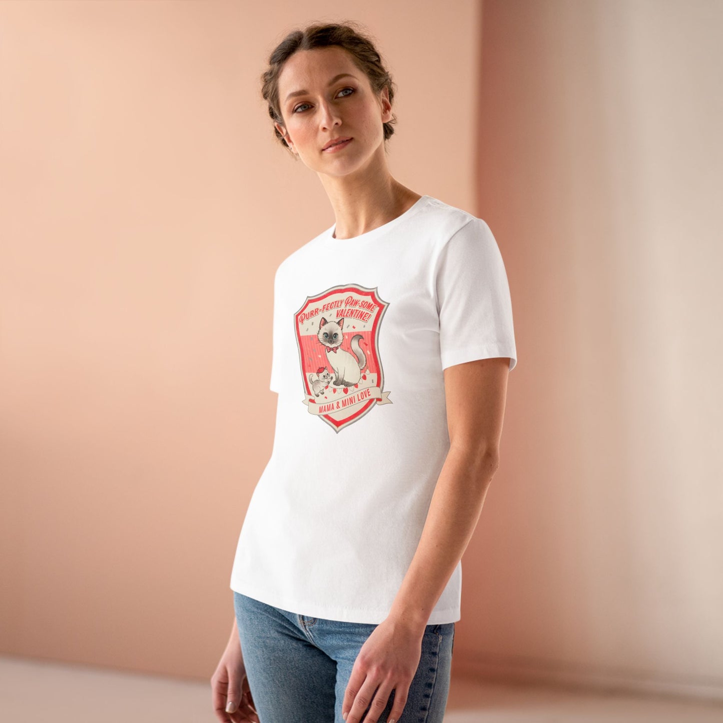 Woman wearing white t-shirt with vintage cat and kitten Valentine design, pink background