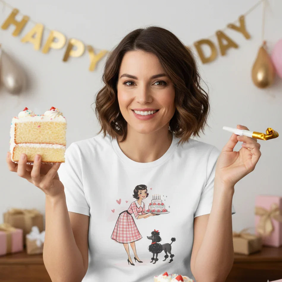 Woman holding a slice of cake and a birthday candle, wearing a t-shirt with a graphic design, in a celebratory setting.