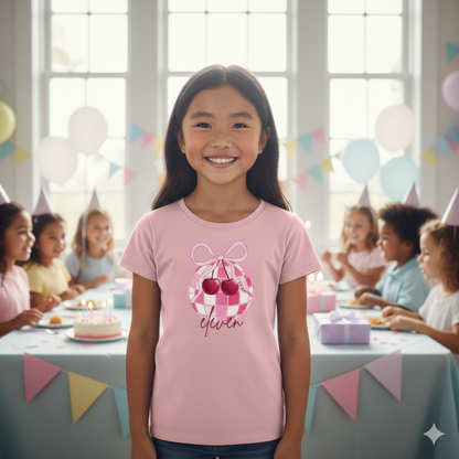 Young girl in a pink t-shirt with a cherry design at a birthday party.